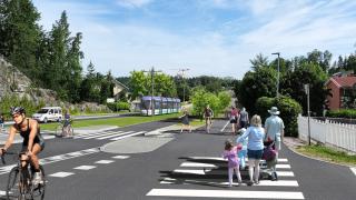 Havainnekuvassa on kävelijöitä ja pyöräilijä katumaisemassa.